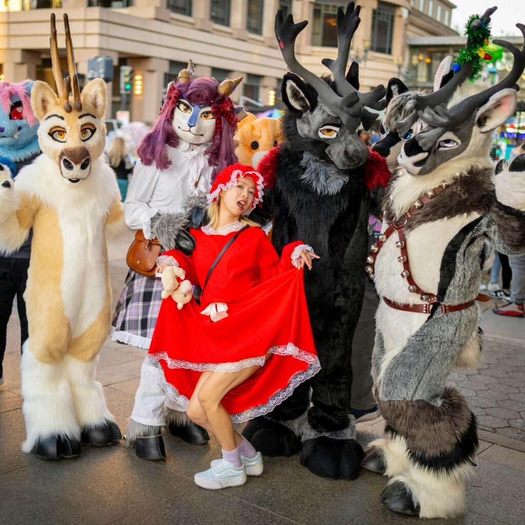 group of furries in fursuits with cosplayer