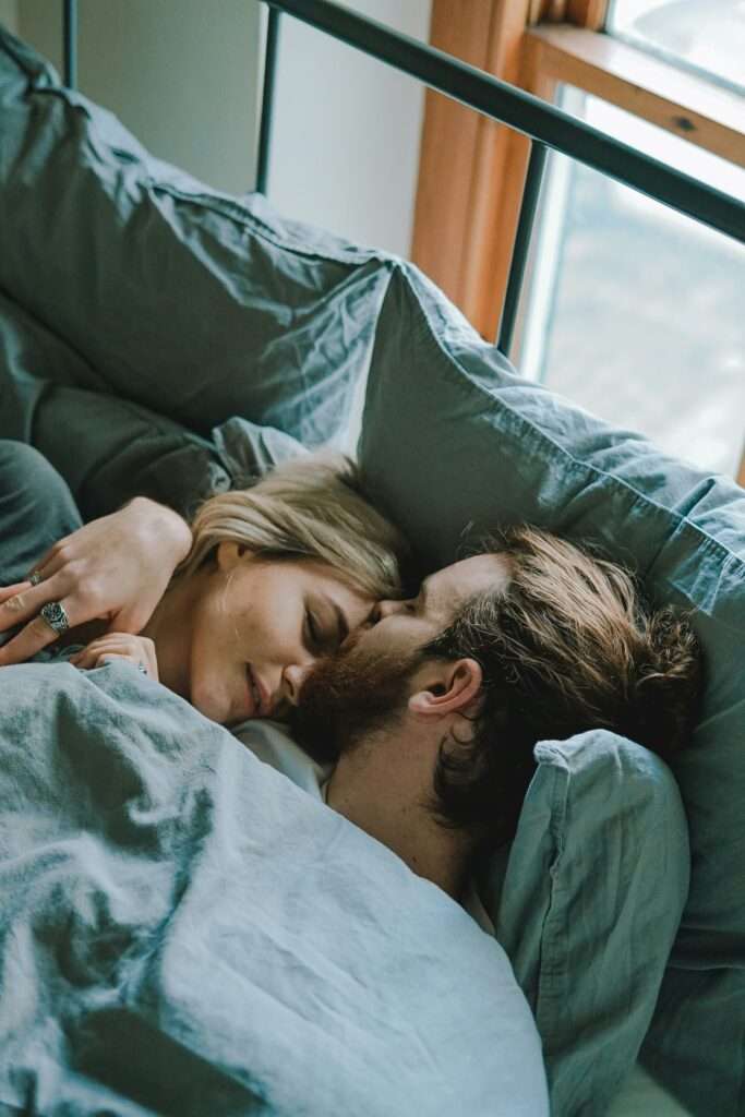 Young couple kissing in bed